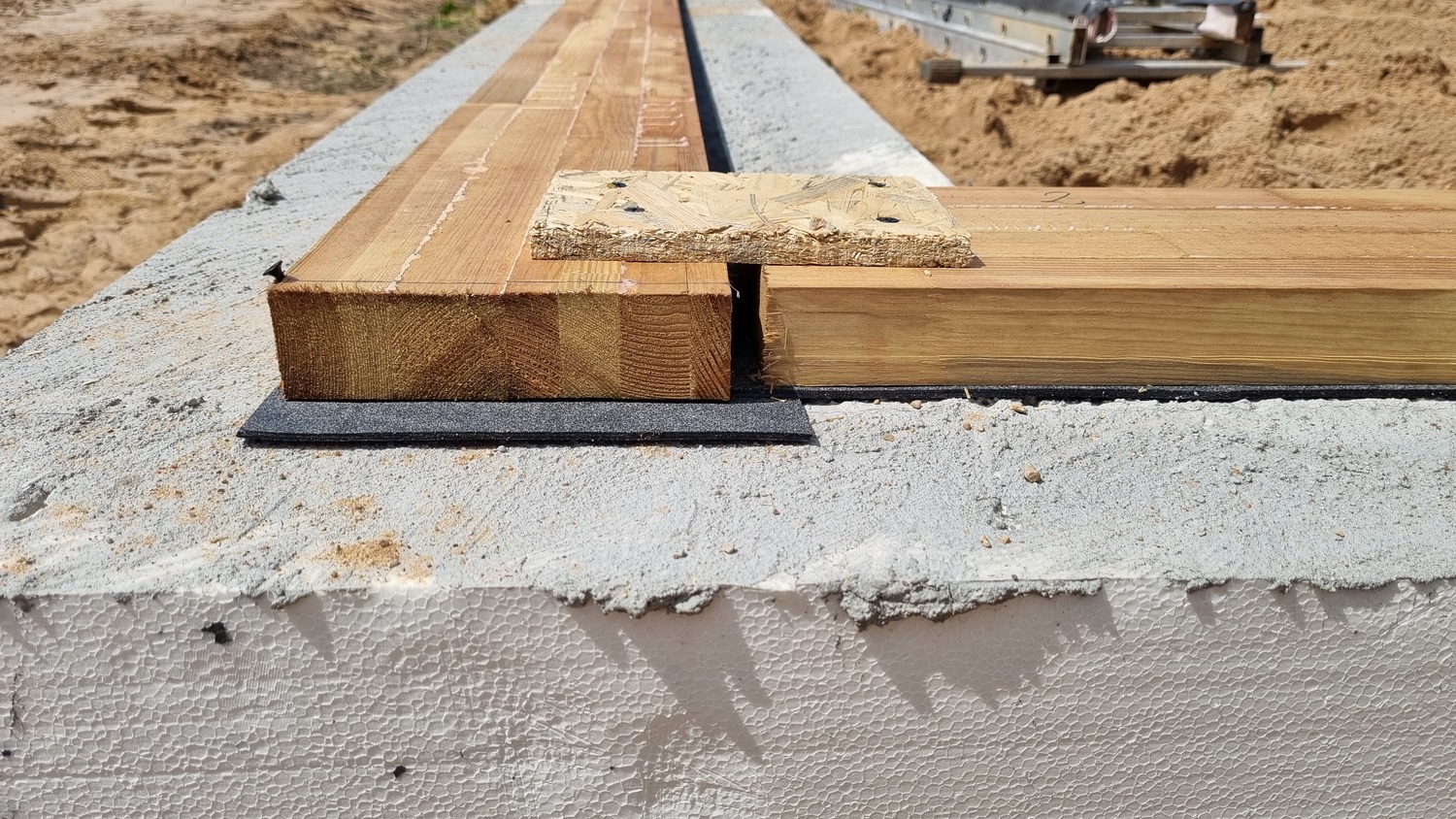 Installation of the Bottom Beam of the SIP House